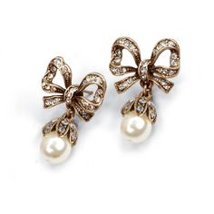 "These earrings feature our exquisite dimensional bows, set with 75 glimmering Swarovski crystals. 8mm pearls. Just the right size - demure and graceful. 1\" long by 0.75\" wide. Choice of Silver or Bronze finish. Post back. Designed and made in our Los Angeles studio. Matching piece: https://www.etsy.com/listing/215392898/bow-necklace-pearl-bow-silver-bow?ref=shop_home_active_1&ga_search_query=bow Contact us for bulk pricing and wholesale information." Jewelry Pearl Earrings, Ribbon Earrings, Locket Bracelet, Pearl Bow, Bow Necklace, Bow Jewelry, Silver Bow, Gold Pearl Earrings, Earrings Pearl