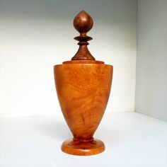 a wooden vase sitting on top of a white table