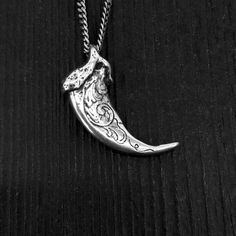 My engraved wolf claw necklace, originally cast from a real North American Grey Wolf in solid sterling silver. Measuring 1-1/4", this one came from a large specimen, they're not usually this big. Beautifully scroll engraved on both sides, as well as the front curve, making this ornately sculptured wolf claw the nicest that you'll find. No bail or jump ring is needed, the chain passes directly though a hole that I carefully bore through the knuckle. It maintains the beautiful silhouette of the cl Scroll Engraving, Claw Necklace, Belle Silhouette, Wolf Jewelry, Beautiful Silhouette, Silver Wolf, Nature Necklace, Grey Wolf, Inspired Jewelry