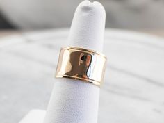 This vintage yellow gold band is absolutely stunning! Also called a cigar band, this ring has a high polish and beautiful shine. The yellow gold has a rich warmth to it that makes the ring all the more eye-catching. Metal: 14K Yellow Gold Width of Band: 12.1 mm Height off Finger: 1.0 mm Ring Size: 6.25 Marks: "14K" Stamped on the inside band Vintage Yellow, Gold Band, Eternity Bands, Cigars, Gold Bands, Wedding Band, Wedding Bands, Ring Size, Yellow Gold