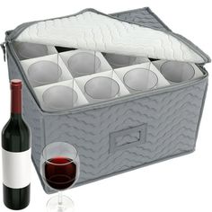 a bottle of wine and some glasses in a cooler with the lid open next to it