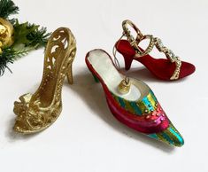 "Vintage Shoe Ornaments, Girl Ornaments, High Heeled Shoe Christmas Ornaments, Girlfriend Gift Ornaments, Shopper Ornaments, Set of 3.    These three pieces \"stand\" and could be used sitting on a mirror, in addition to hanging on the tree.  1.  Gold High Heel, made of gold sparkly acrylic, with lace edges, and a gold bow on the toe.  Measures approx 4\" wide, 3\" tall. 2.  Glass Shoe, with great colors.  Measures 6\" long, 1 1/2\" tall. 3.  Red Velvet shoe, with acrylic top and rhinestone stra Velvet Shoe, Glass Shoe, Gift Ornaments, Shoe Ornaments, Lace Edges, Glass Shoes, Gold High Heels, Vintage Shoe, Velvet Shoes