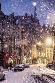 a city street is covered in snow at night