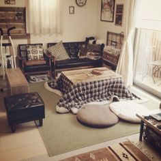 a living room filled with lots of furniture and decor on top of carpeted flooring