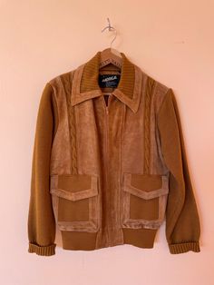 "Rustic and Fun Zip Front Kint and Suede Jacket. 2 Pockets with flap closure. Knit sleeves, and lower back. Knit detail throughout front and at neck of collar and waistline. Suede detail on front and collar as well as lower back. 1980s MEASUREMENTS:  Small Neck: 17\" Chest: 38\" Pit to Pit: 19\" Length, from neck seam: 24\" Hips: 32\" Sleeve: 32 1/2\"  Shoulder seam to cuff: 24 1/2\" (cuffed 22 1/2\") LABEL: Madrigal (S) Knit: Acrylic Leather: 100% Cowhide Lining: Nylon Made in Taiwan" Retro Fall Sweater For Workwear, Retro Fall Sweater For Work, Retro Workwear Sweater For Fall, Retro Collared Winter Sweater, Retro Collared Sweater For Winter, Vintage Collared Sweater For Winter, Fitted Brown Outerwear With Ribbed Collar, Fitted Brown Collared Sweater, Retro Fitted Cardigan For Winter