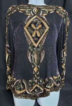 This gorgeous black blouse with several colored sequins and colored beads has a tag stating Oleg Cassini. It is a size large.  Measurements are Shoulder flat across is 17 inches,  Bust 20 1/2 inches flat across,      Waist 21 inches flat across,         Length  of blouse up and down starting from shoulder down is 22 inches. The geometric and curvelinear patches are gray, green and gold sequins. On black blouse open space are cylinder colored pink purple iridescent beads. The zipper works well bu Large Sequins, Oleg Cassini, Eye Beads, Gold Sequins, Beautiful Blouses, May 5, Gray Green, Dress Clothes For Women, Open Space