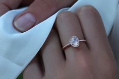 a close up of a person's hand with a ring on top of it