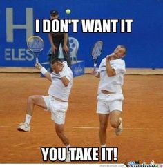 two men playing tennis on a clay court