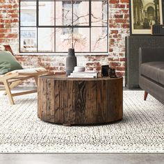 a living room with brick walls and furniture in the corner, including a coffee table