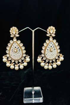 Description: Enhance your elegance and make a statement with our Gold Plated Dazzling Royal Kundan Beaded Earrings. The intricate design and sparkling kundan beads add a touch of royalty to your outfit. Perfect for any occasion, these earrings will surely impress. About: Best for gifting or for personal use, wear it to any occasion and be the spotlight. Eye-catching and unique jewelry that will set you apart. Gift this piece to a loved one and see their face light up with joy. Silver Pooja Items, Glass Bangles, Silver Toe Rings, Gold Chain With Pendant, Kundan Earrings, Face Light, Silver Anklets, Bridal Bracelet, American Diamond