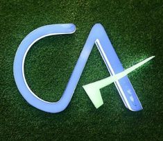 the letter c is made out of plastic and has an arrow on top of it