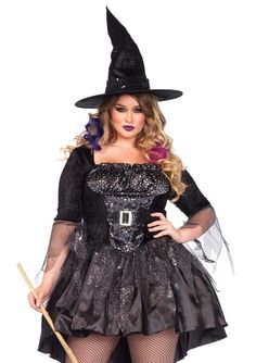 a woman in a witch costume holding a broom