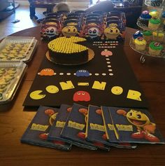 a table topped with lots of cakes and cupcakes