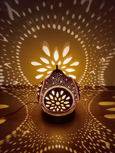 an intricately designed lamp is lit up in the dark with white lights on it