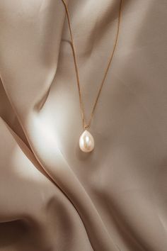 The Giulia Pearl Necklace is handcrafted with a freshwater pearl drop and 14k gold filled box chain. Pair with the Giulia earrings for a perfect match.  Packaged in an elegant plastic-free reusable jewelry box, they make the perfect gift or special treat for oneself. *14k gold-filled chain and components *Freshwater pearl *Hypoallergenic, suitable for even the most sensitive skin *Delivered in a 100% silk jewelry pouchette inside a gift box *Sustainable magnetic closure jewelry box and customiza Everyday Pearl Drop Jewelry, Everyday Drop Pearl Jewelry, Elegant Pear-shaped Drop Necklace Gift, Timeless Pear-shaped Necklace For Gift, Timeless Pear-shaped Necklace Gift, Hypoallergenic Pearl White Teardrop Jewelry, 14k Gold-filled Teardrop Pearl Chain Jewelry, Timeless Teardrop Pearl Pendant Jewelry, 14k Gold-filled Pear-shaped Pearl Drop Jewelry