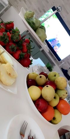 there are many different types of fruits on the table and one has a fork in it