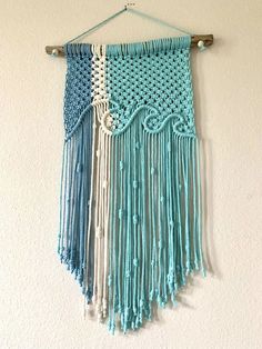 a blue and white crocheted wall hanging