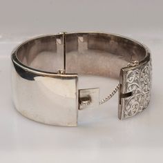 ...ORIGINAL PRICE $1350.00 Now $850.00...Just like the flowers decorate the rose gardens of England, engraved flowers and vines decorate this gorgeous antique English bangle bracelet.  Crafted from sterling silver, this 1920's bracelet is a dainty yet sturdy piece of history.  Signed by Birks, and made in England, this bangle has a push button clasp and a safety chain for added security.  What a wonderful addition for your jewelry collection.Antique Bracelet1920'sSigned Birks Made in EnglandSter Rose Gardens, Engraved Cuff, Engraved Flower, Antique Bracelets, Safety Chain, Push Button, Bangle Bracelet, Flower Decorations, Cuff Bracelet