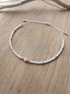 Delicate minimalist string cord bracelet made with creamy and gold toho round beads size 11. Simple, filigree and elegant design at the same time. It can be worn with casual or fancy outfit even for wedding dress The bracelet is adjustable thanks to a macrame slide knot. It is about 15 cm when fully tightened and about 28 cm when expanded. This bracelet is perfect for minimalist jewelry lovers or combine with other bracelets to create a stack!  If you need different size, feel free to ask Thank for visiting my shop! Please contact me if you have any questions!  ~~ Care instructions: To ensure that your piece of jewellery lasts a particularly long time, please avoid excessive contact with water, creams and perfumes and take it off overnight. Elegant Gold Beads Friendship Bracelets As Gift, Elegant Gold Beaded Friendship Bracelets As Gift, Elegant Tiny Beads Friendship Bracelets As Gift, Elegant Friendship Bracelets With Tiny Beads As Gifts, Elegant Beaded Friendship Bracelet As A Gift, Elegant Friendship Bracelets With Tiny Beads, Delicate Gold Beaded Friendship Bracelets, White Delicate Adjustable Friendship Bracelets, Delicate White Adjustable Friendship Bracelets