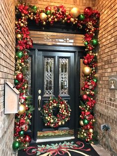 a decorated front door with wreaths and ornaments