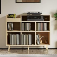 an entertainment center with bookshelf and stereo system on the shelf in front of it