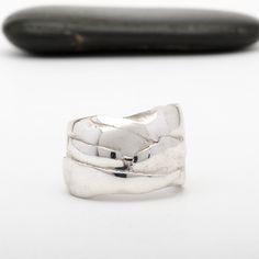 This "Odin" silver ring is handmade in Fine Silver (99.9% pure silver). This unique piece is entirely molded by hand, using the silver clay technique. The style of this ring is inspired by the Vikings and the Old Norse mythology. Browse our complete collection of custom one of a kind fine silver jewelry. Hand Forged Wide Band Sterling Silver Ring, Silver Hand Forged Wide Band Open Ring, Hand Forged Silver Ring With Thick Band, Unique Hand Forged Sterling Silver Wide Band Ring, Silver Hand-forged Wide Band Ring For Anniversary, Unique Hand Cast Sterling Silver Engraved Ring, Hand Forged Sterling Silver Rings With Thick Band, Unique Sterling Silver Rings With Thick Band, Unique Engraved Wide Band Ring In Sterling Silver