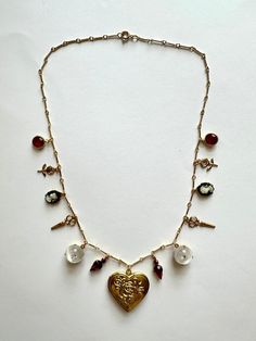 18" gold plated chain mixed with vintage brass, Swarovski and misc charms.  Perfect for dressing up any look. Vintage Charm Metal Necklace In Costume Jewelry Style, Vintage Charm Metal Costume Jewelry Necklace, Vintage Charm Metal Necklaces For Costume Jewelry, Vintage Style Metal Necklaces With Charms, Vintage Gold Necklaces With Heart Charm, Gold Brass Heart Charm Necklaces, Gold Brass Charm Necklace With Heart Charm, Antique Gold Necklaces With Charms, Gold Necklace With Heart Charm For Vintage Collection