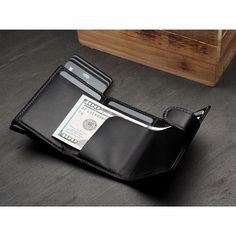 A small, yet highly practical wallet. It will store the essentials without taking up much space.  Made of fine, exclusive Italia leather. Cards, banknotes - you always have them close at hand, organised in several easily accessible pockets. A gradual card ejecting "pulse" mechanism ensures easy and quick access to the wallet's contents. Thanks to the Rfid blocking technology used in the wallet design, your sensitive data and credit card funds are completely safe and protected from unauthorised reading or theft.  Registered design - unique and original! Ideal for minimalists and all those for whom less is more. Dry clean only. Made in Poland. Modern Black Trifold Wallet For Daily Use, Modern Black Wallet For Daily Use, Black Multifunctional Rectangular Wallet, Wallet Aesthetic, Black Textured Leather Travel Wallet, Black Textured Leather Rectangular Wallet, Wallet Design, Digital Wallet, Rfid Wallet