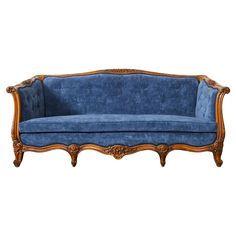 an old fashioned blue couch with wood trimming