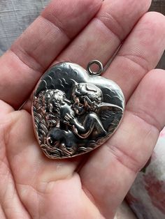 Amazing Unger Brothers locket in their most famous Love's Dream pattern with Cupid Kissing Psyche. Their heart lockets are hard to come by and feature the Unger Bros Logo in the top. It is amazing Repousse work! It is over 120 years old so please keep in mind when purchasing. The hinge and clasp work great it closes with a snap. It does require delicate handling due to age.  Unger Brothers are regarded as some of the best early American Silversmiths. Their items are highly collectible and retain value as this locket is likely over 120 years old. It would make for a wonderful heirloom with lots of history.   This Unger Bros Art Nouveau locket is featured in the Unger Bros catalogs with all of their locket designs. It's dated from late 1800s to early 1900s. It's in Amazing condition for the Vintage Pendant Locket Necklace For Valentine's Day, Victorian Locket For Valentine's Day, Victorian Locket Jewelry For Valentine's Day, Victorian Jewelry With Heart Charm For Anniversary, Antique Charms Locket Necklace For Wedding, Antique Locket Jewelry For Anniversary Gift, Vintage Locket Necklace With Large Pendant For Gift, Antique Jewelry For Valentine's Day Anniversary Gift, Heirloom Engraved Jewelry For Valentine's Day