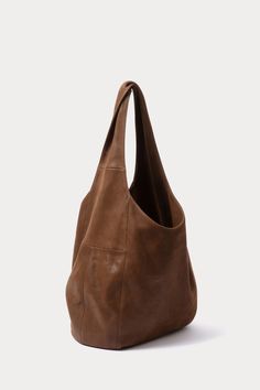 Oversized, unstructured hobo bag with a large top handle, in soft leather. 100% Leather Interior Pocket Length: 12” Width: 18” Shoulder Strap: 20" Shoulder Strap Drop: 14.5" Made in Peru Bag Spill, Foraging Bag, Give Me My Money, Jewelry Fancy, Hobo Tote Bag, Womens Designer Bags, Bags To Make, The Glow Up, Brown Tote