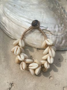 Introducing our new beach accessory: the OCEAN COWRIE SEASHELL BRACELET. Crafted with natural shells sourced from the depths of the ocean in Thailand, this statement piece beautifully captures the essence of the sea. Each shell is carefully combined to create a captivating and unique representation of oceanic beauty. Perfect for beach outfits, honeymoons, resort wear, or gift for your love ones, this choker necklace is a versatile addition to your wardrobe. What sets it apart is our commitment t Seashell Choker, Seashell Bracelet, Bracelets Handmade Diy, Beach Outfits, Honeymoons, Beach Accessories, Resort Wear, Handmade Bracelets, Beach Outfit