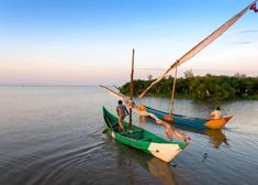 two small boats with people on them in the water