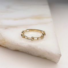 Look no further for the perfect stacker: Our Small Tiffany Link ring is dainty and beautiful, with just the right amount of texture to give it an exciting edge! Not only is it a chic accessory, but it's also looks great paired with our other stacking bands. Materials: 10K Yellow Gold Measurements: Sizes 4-8 Half sizes available! White Gold Stackable Open Midi Rings, Modern Stackable Rings For Everyday, Classic Stackable Chain Ring For Promise, Classic Stackable Chain Promise Ring, Everyday Stackable Midi Rings With Open Ring Shape, Modern Stackable Midi Rings For Everyday, Stackable Open Chain Ring For Promise, Stackable Open Ring Midi Rings For Everyday, Classic Round Stackable Chain Ring