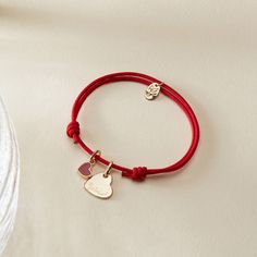 Our Personalized Valentines Heart Bracelet is a sweet symbol of love and affection, perfect for Valentine's Day and beyond. Each bracelet features two charms: a dainty and romantic mini red heart, and a shiny heart charm to hand-engrave with the name of a true love. Both charms move freely along your choice of colorful braid.18K Champagne Gold Plated or 925 Sterling SilverHeart: 0.4x 0.4Mini Red Lacquer Heart: 0.25 x 0.21Braid made of a durable, colourfast polyesterFully adjustable sliding knot Valentine's Day Double Heart Adjustable Charm Bracelet, Adjustable Heart-shaped Charm Bracelet With Heart Charm, Double Heart Charm Bracelet For Valentine's Day, Red Heart Charm Bracelet For Friendship, Valentine's Day Adjustable Name Bracelet With Heart Charm, Valentine's Day Double Heart Charm Bracelet For Friendship, Adjustable Heart Charm Name Bracelet For Valentine's Day, Adjustable Name Bracelet With Heart Charm For Valentine's Day, Personalized Red Charm Bracelet For Valentine's Day