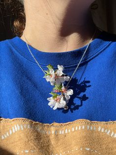 Created by requests, these dainty handmade silver coil necklaces are great for carrying any little sprig of flowers with you!  ~ Simply slide a little (real or fake) flower into the base holder to display! ~ Handmade in Amesbury, MA by Holly with love and sterling silver plated wire!🌿 ~ Purple flower is in a medium cage & yellow is in a small. (no flower included). Sizes: Small: pendant is .75" Medium: pendant is 1.5" Large: pendant is 2" This listing is for one (1) Flower Holder Necklace. PEND Whimsical Spring Jewelry Gift, Bohemian Sterling Silver Flower Necklace, Delicate Spring Necklaces For Gifts, Delicate Spring Jewelry Gift, Delicate Spring Jewelry For Gift, Delicate Necklace For Spring Gift, Spring Sterling Silver Jewelry With Flower Charm, Spring Flower Charm Necklace For Gift, Spring Flower Pendant Jewelry Gift