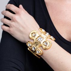 Product Description: Boldly sized, this tribal gold cuff bracelet is both sophisticated and statement making.   ﻿﻿Style Number: ﻿7653BX Clear Crystal Bracelet, Gold Cuff Bracelet, Dragon Bracelet, Leaf Bracelet, Gold Bracelet Cuff, Toggle Bracelet, Gold Cuffs, Hinged Bracelet, Fancy Jewelry