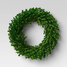 a green leafy wreath hanging on the wall