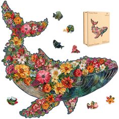 an image of a whale with flowers and butterflies on it's back, surrounded by other items