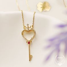 Our Rosa Key Three-Way Necklace features a crowned heart-shaped key pendant with a round ruby gemstone at the center and a white topaz rose flower charm. The key represents unlocking one's heart while the rose flower symbolizes purity and devotion. A versatile necklace that can be worn in three ways. You can wear the heart key alone for a subtle and elegant look, the glittering rose flower alone for a more feminine look, or both the key and the flower together for a more striking look. A meaning Meaningful Necklace, Goddess Jewelry, Heart Key, Heart And Key, Rose Pendant, Ruby Rose, Key Pendant, Ruby Gemstone, Feminine Look