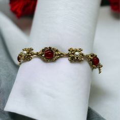 This Vintage Gold Tone Bracelet With Faux Pearl And Red Gem Detailing Adds An Elegant Touch To Any Outfit. Its 7.5" Length Ensures A Comfortable Fit. Gold Tone Link Bracelet Faux Pearl Accents Eye-Catching Red Gem Vintage Style Comfortable 7.5" Size Size: Womens 7.5" Condition: New With Box Check Out My Bundle Discount! Put Four Or More Items In Your Bundle And I'll Also Give Free Shipping! Gold And Red Accessories, Gold Bracelet Vintage, Red And Gold Jewelry Aesthetic, Vintage Red Bracelets For Party, Formal Red Metal Bracelets, Red Vintage Party Bracelets, Vintage Red Bracelets For Wedding, Vintage Red Bracelet For Wedding, Vintage Red Wedding Bracelet