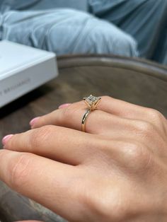 a woman's hand with a ring on it