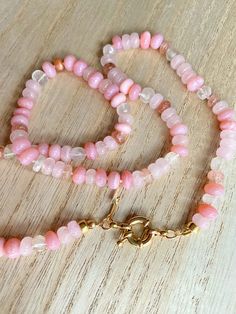 This beautiful pink gemstone necklace makes a perfect gift! Each bead is hand knotted onto silk thread, which gives the necklace a lovely drape.Necklace is 21 inches long, hand knotted with white silk string, gold filled beads, and has gold filled clasp. This is a stunning necklace that completes any outfit. This necklace is a perfect gift!   GEMSTONES  Pink Opal (dyed) Sunstone Rose Quartz Aquamarine Gold Filled Findings BENEFITS OF A HAND KNOTTED NECKLACE 1. A knotted necklace is safe and secu Luxury Hand-knotted Beaded Necklaces As Gift, Beaded Pink Opal Necklaces For Jewelry Making, Handmade Pink Crystal Necklaces With Round Beads, Pink Opal Round Beads Necklace For Gift, Handmade Pink Crystal Bead Necklace, Handmade Pink Crystal Necklace As Gift, Handmade Pink Crystal Necklace For Gift, Rondelle Crystal Necklace With Gemstone Beads, Pink Beaded Crystal Necklaces With Round Beads