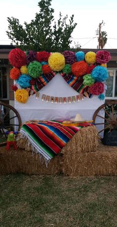 a bed made out of hay with colorful decorations