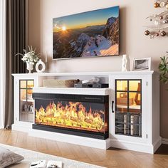 a living room with a fire place in the center and a painting on the wall