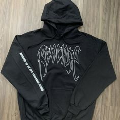 This Is The Xxxtentacion Revenge Hoodie With "Revenge Is In The Creators Hands" On The Sleeve On A Black Hoodie With A White Design. Winter Band Merch Sweatshirt For Streetwear, Band Merch Hoodie For Winter Streetwear, Winter Band Merch Hoodie For Streetwear, Winter Streetwear Band Merch Hoodie, Edgy White Sweatshirt For Streetwear, White Grunge Hoodie For Streetwear, Black Long Sleeve Sweatshirt With Band Logo, Black Band Logo Sweatshirt For Streetwear, Black Band Logo Sweatshirt For Winter