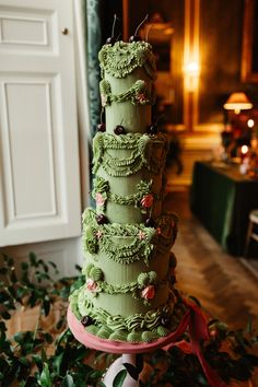 a large green cake sitting on top of a table