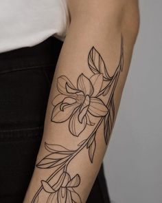 a woman with a flower tattoo on her arm