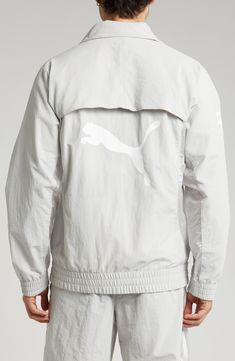 This relaxed-fit track jacket is part of a collab with PLEASURES and is inspired by a clash of racing and punk-inspired streetwear. Bold tonal branding for both labels subtly reflects against the sleek nylon on the outerwear, while underarm ventilation keeps it breathable throughout the day. 28" length (size Medium) Front zip closure Stand collar Elastic cuffs and hem Side zip pockets Underarm ventilation Water-repellent 100% recycled nylon Machine wash, tumble dry Imported PUMA has received the Reflective Track Jacket For Streetwear, Sporty Windbreaker With Graphic Print For Streetwear, Functional Track Jacket With Reflective Details For Streetwear, Sporty Track Jacket With Graphic Print, Reflective Long Sleeve Track Jacket For Streetwear, Spring Techwear Track Jacket For Streetwear, Sporty Windbreaker With Reflective Details For Streetwear, Hooded Reflective Track Jacket For Streetwear, Sporty Track Jacket For Spring Streetwear