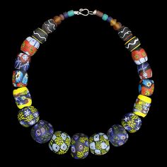 A large necklace comprising of glass bead replicas from Eidem, Norway. Wear as a standalone necklace, or attach between tortoise brooches. For Viking men or women. Total length: approx 50cm (19.7 inch). Beads range from 5mm - 30mm (0.2 - 1.2 inch) wide. Metal clasp for easy closure. Hand-painted & plain glass replica beads from 9th - 10th century Norway. Total weight approx. 302g (10.65oz) approx. Last image shows the original necklace from the museum of Norway. Unique Glass Single Strand Necklace, Unique Single Strand Glass Necklaces, Unique Single Strand Glass Necklace, Artisan Glass Jewelry With Large Beads, Unique Glass Necklaces With Polished Beads, Artisan Glass Bead Necklaces, Artisan Glass Beaded Necklaces, Artisan Glass Necklaces With Round Beads, Unique Glass Necklaces For Jewelry Making